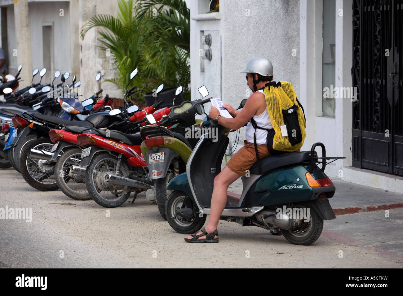 Tourist gets around Cozumel on a scooter Stock Photo Alamy