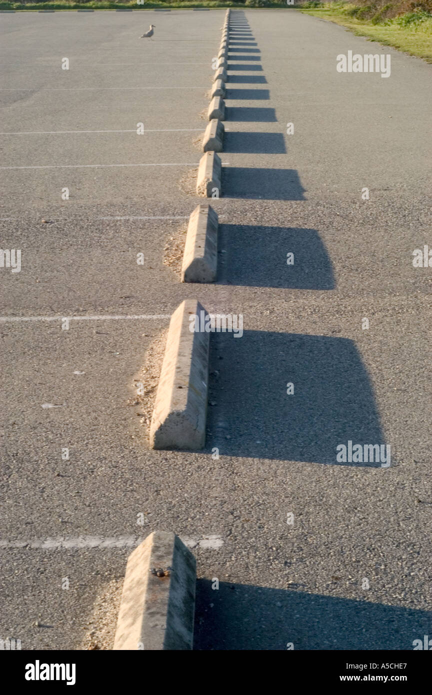 A color vertical image of a row of parking lot stops Stock Photo Alamy