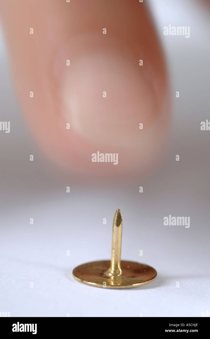 Human finger towards drawing pin Stock Photo Alamy