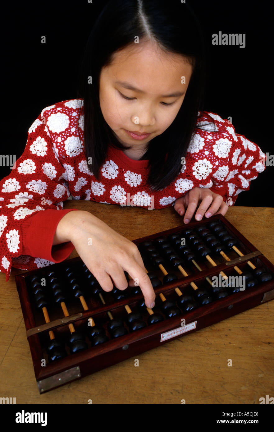 Chinese girl doing calculations with abacus Stock Photo - Alamy