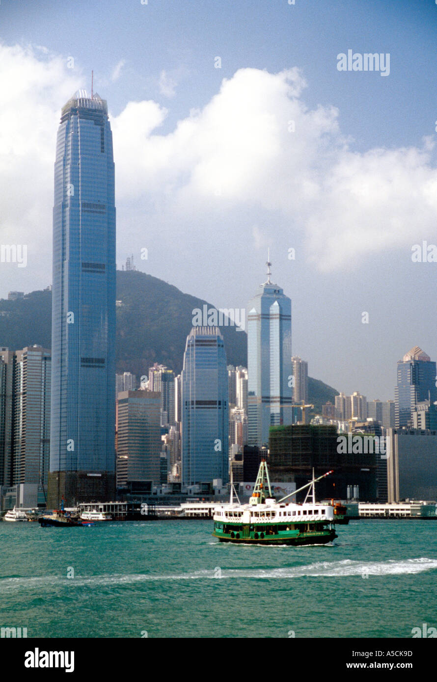 Hong Kong Star Ferry in harbor with skyscrapers in front of Victoria Peak Stock Photo