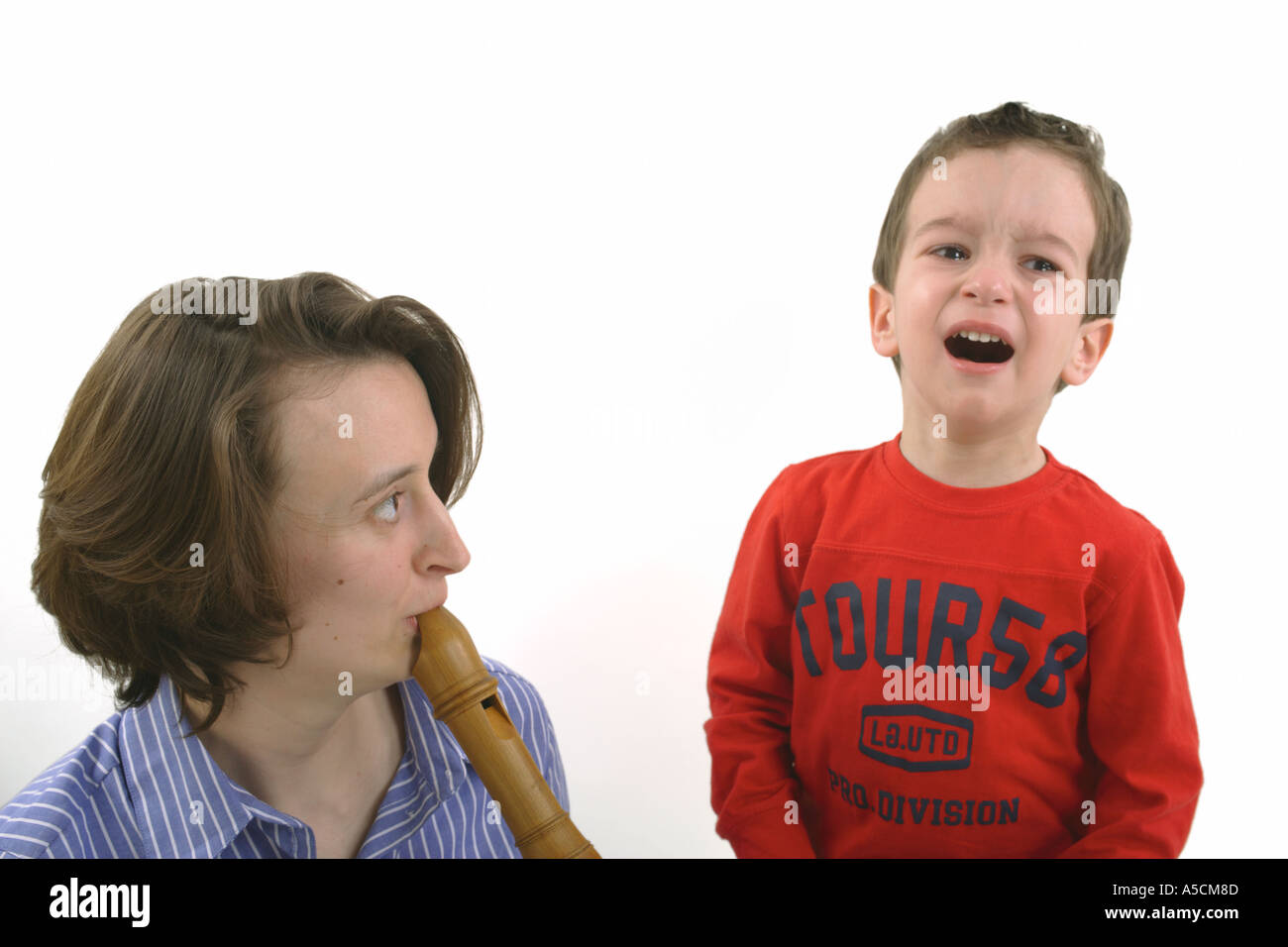 Little boy does not want to listen to the flute Stock Photo