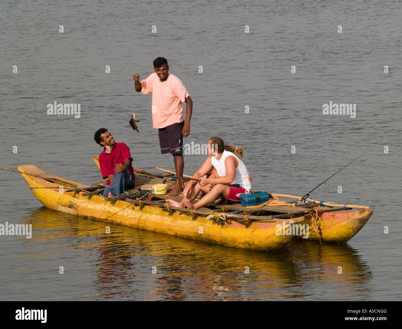 On the Bentota River tourists with locals in Oruwak boats Stock Photo