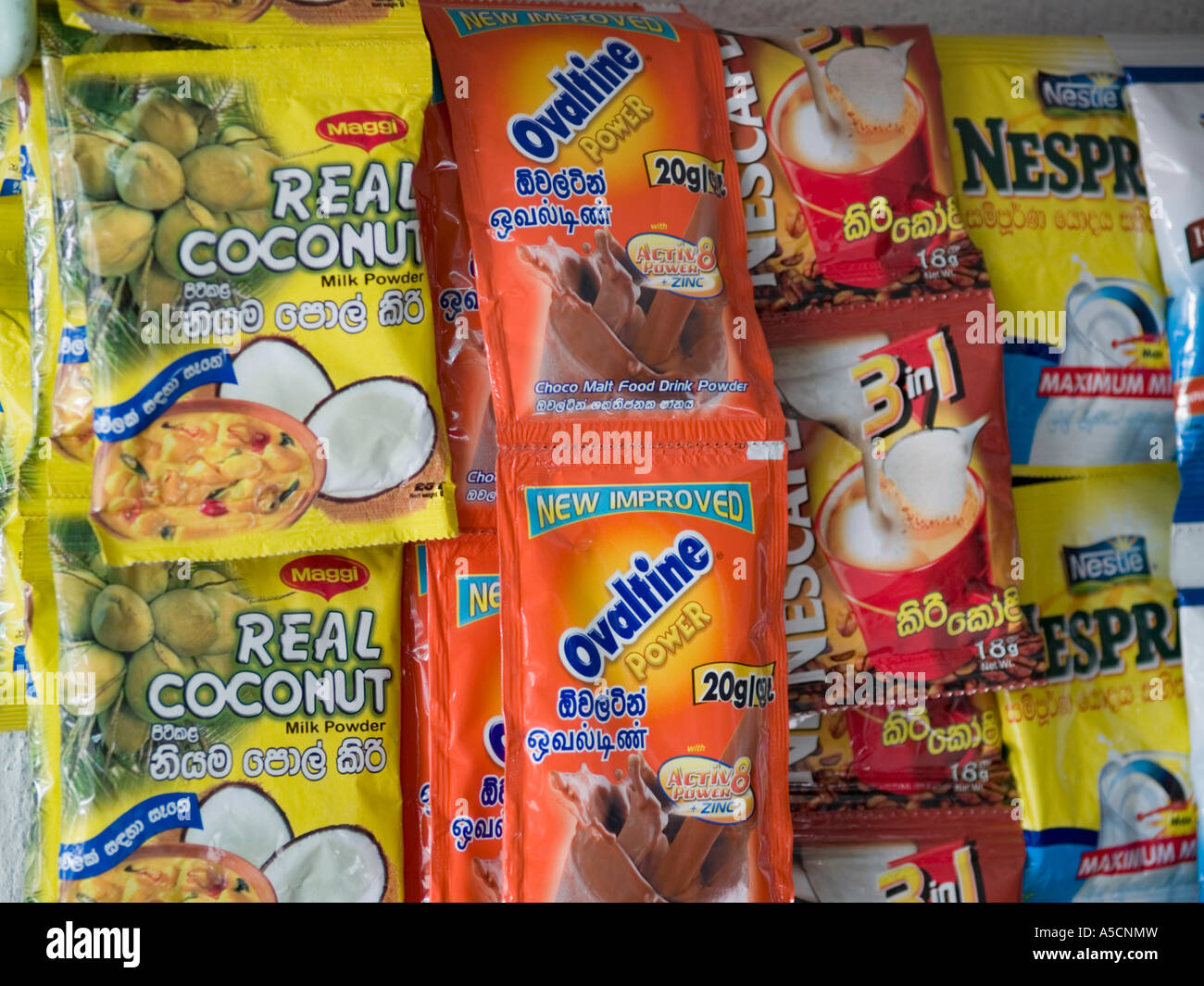 Local and western brands of food in packets in shop Stock Photo