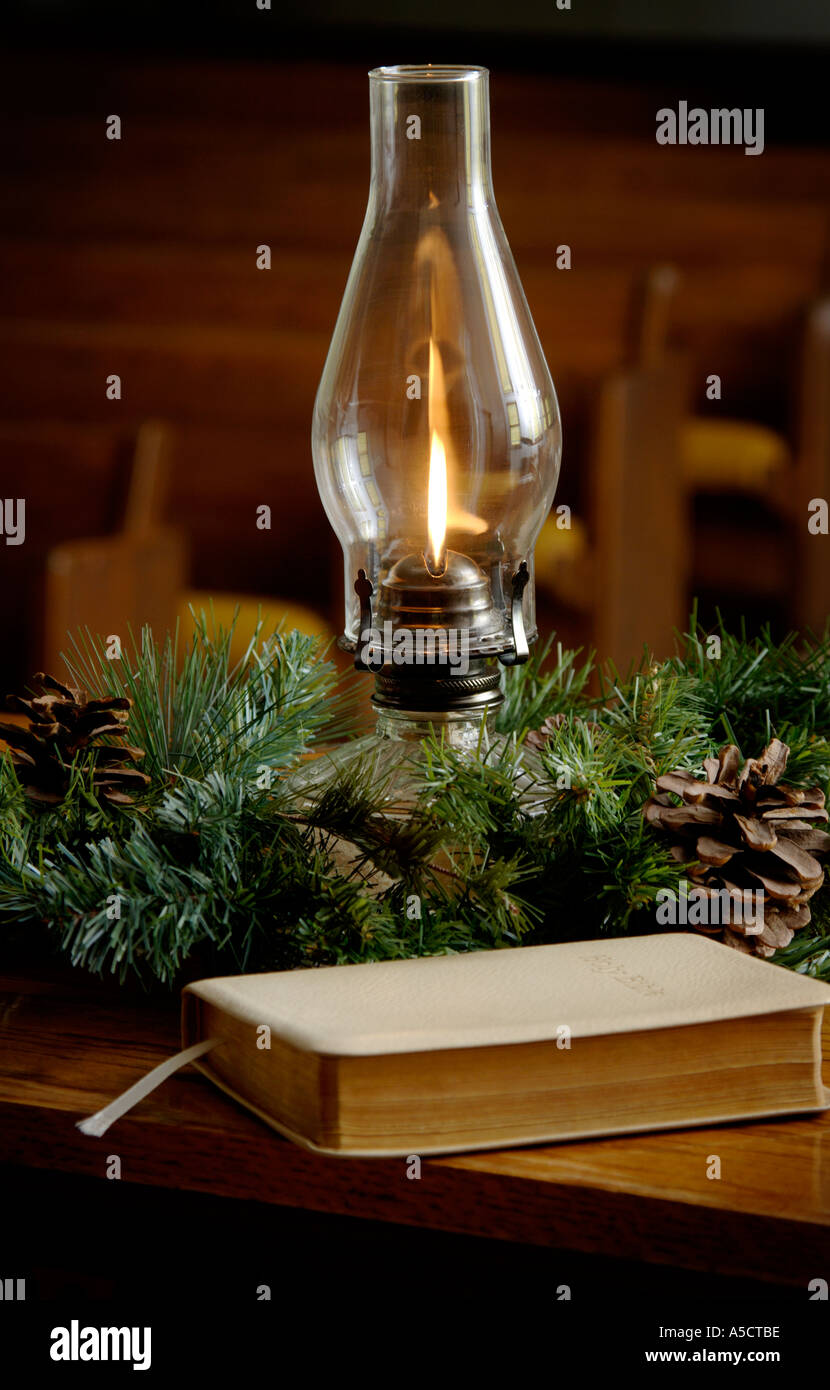 Oil lamp and Bible in church setting Stock Photo Alamy