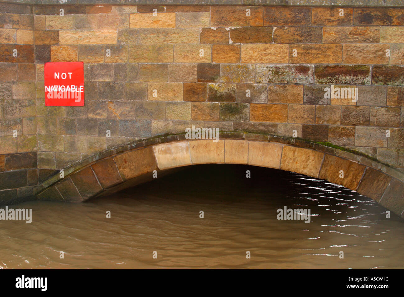 Not navigable sign above high water under bridge in Arundel, West Sussex. Stock Photo