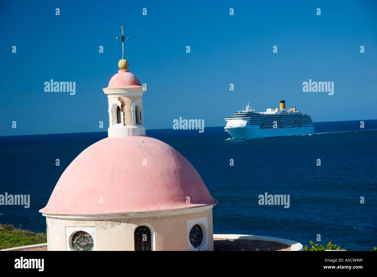 Spanish Fort and church tower in San Juan Peurto Rico with the Carnival cruise ship Victory in
