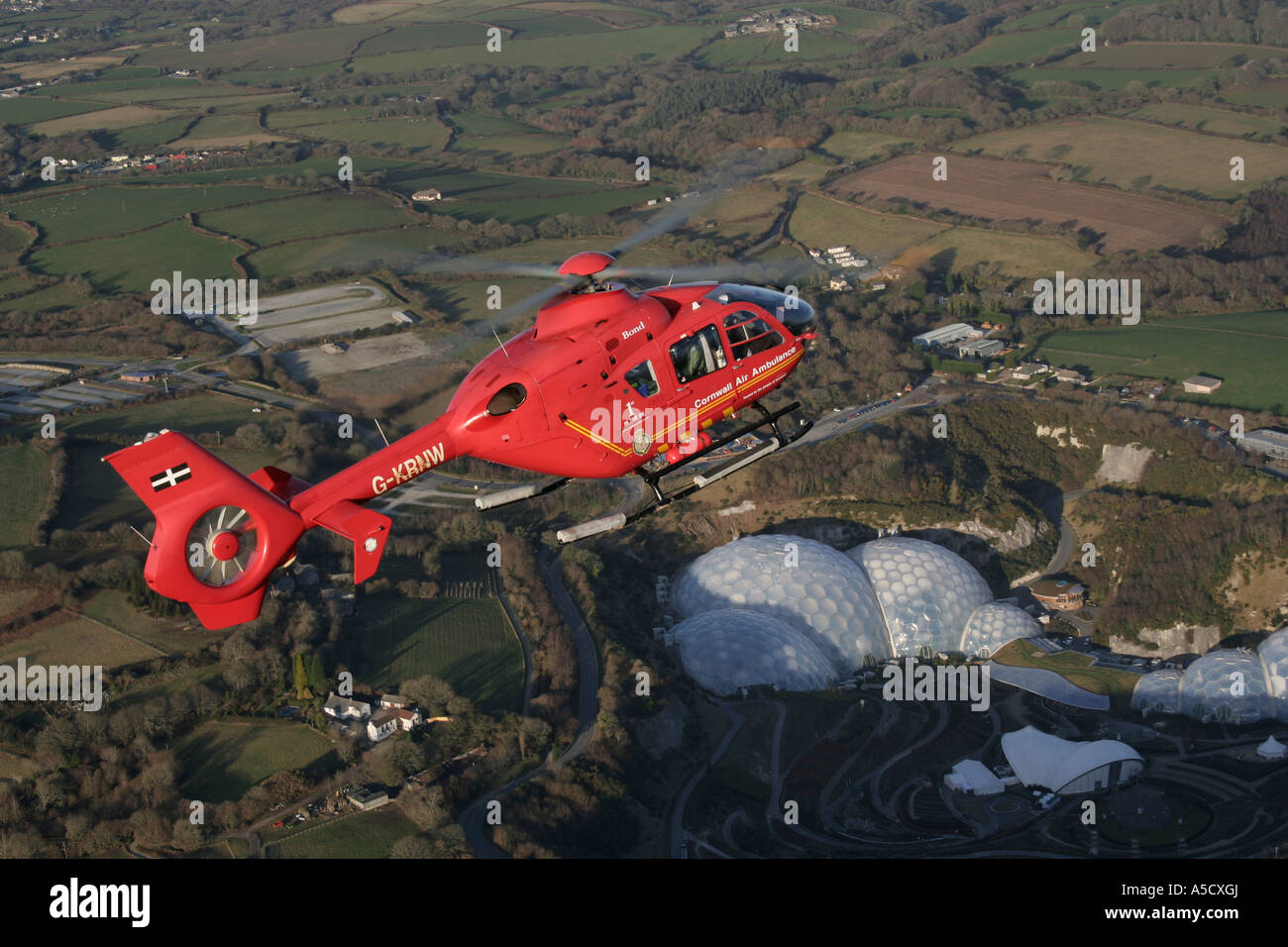 Cornwall EC135 Air Ambulance over Eden Project Stock Photo