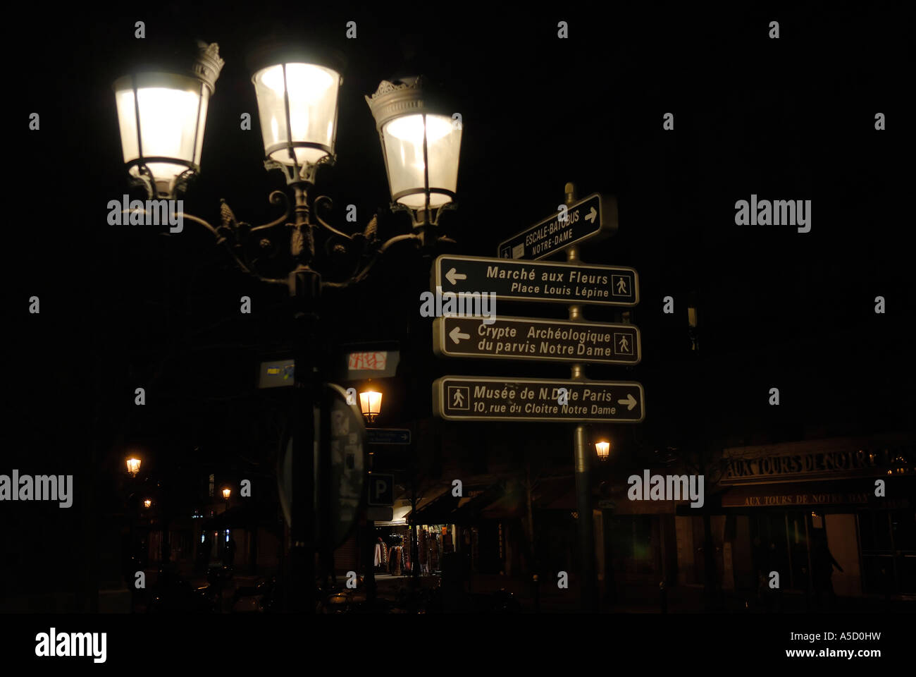 Lights and streets names at a street corner by night in Paris