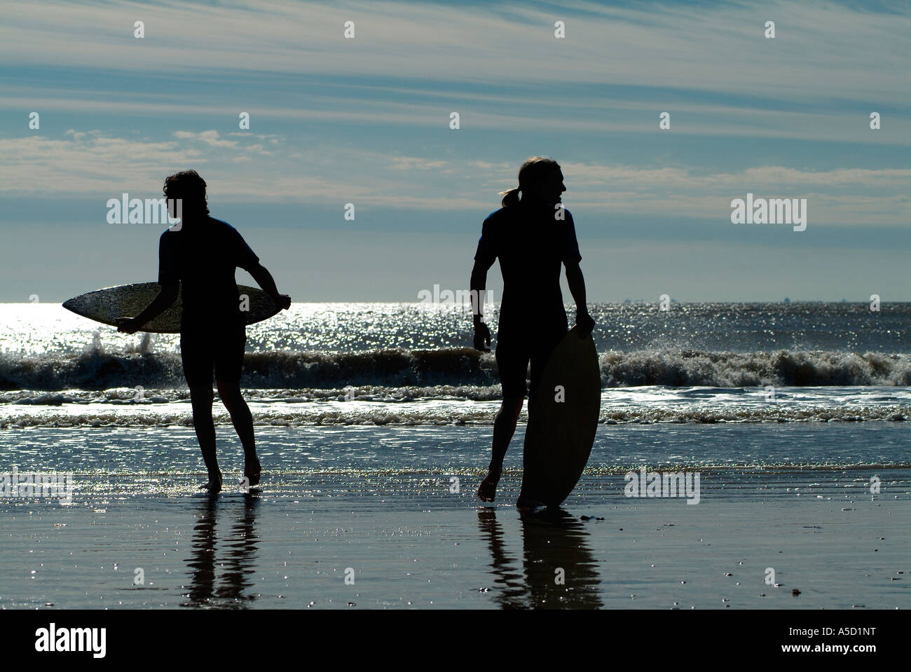 Teen boys with skimboard on the beach Stock Photo