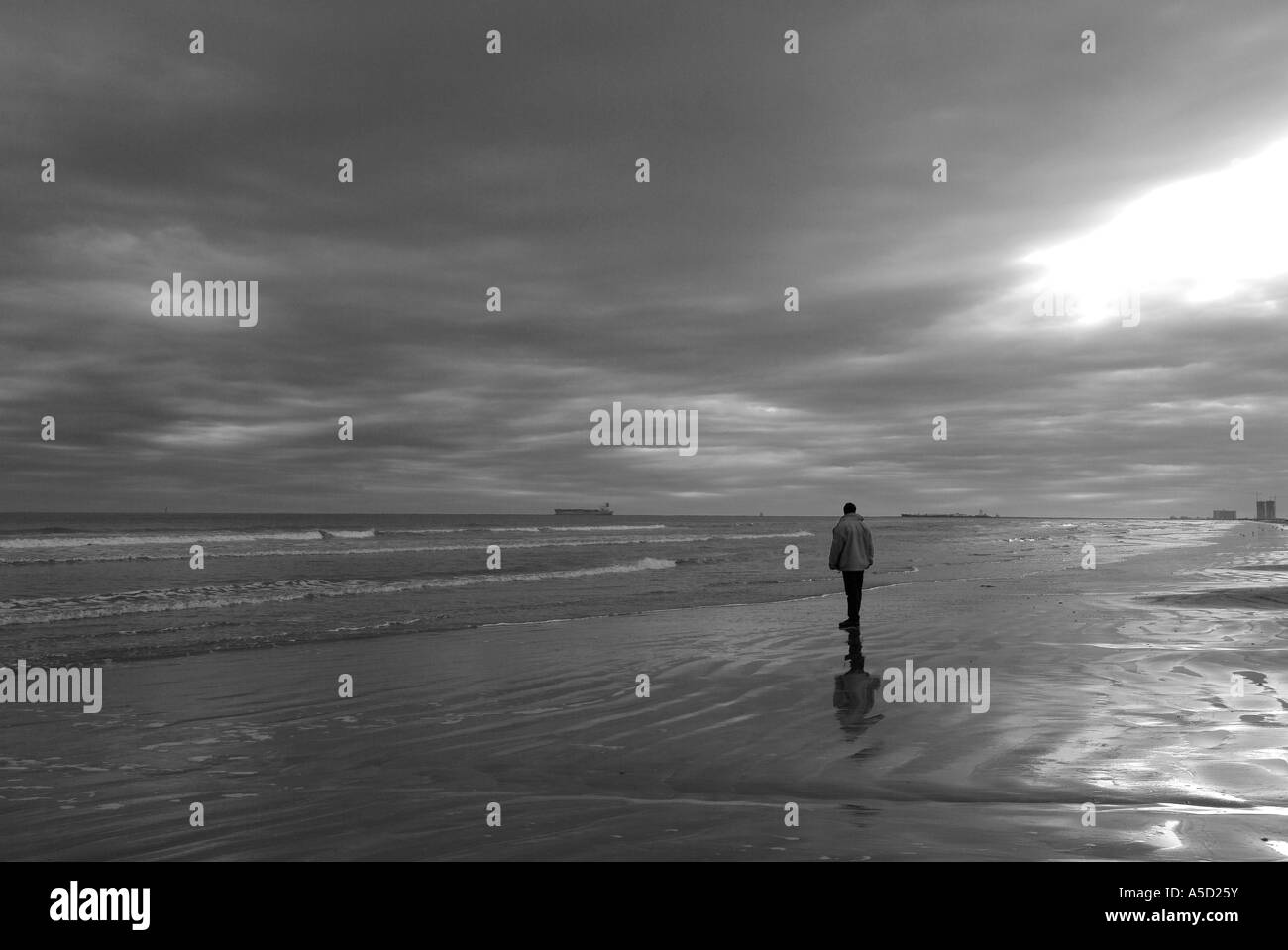 Man walking on a beach on Bolivar peninsula Stock Photo