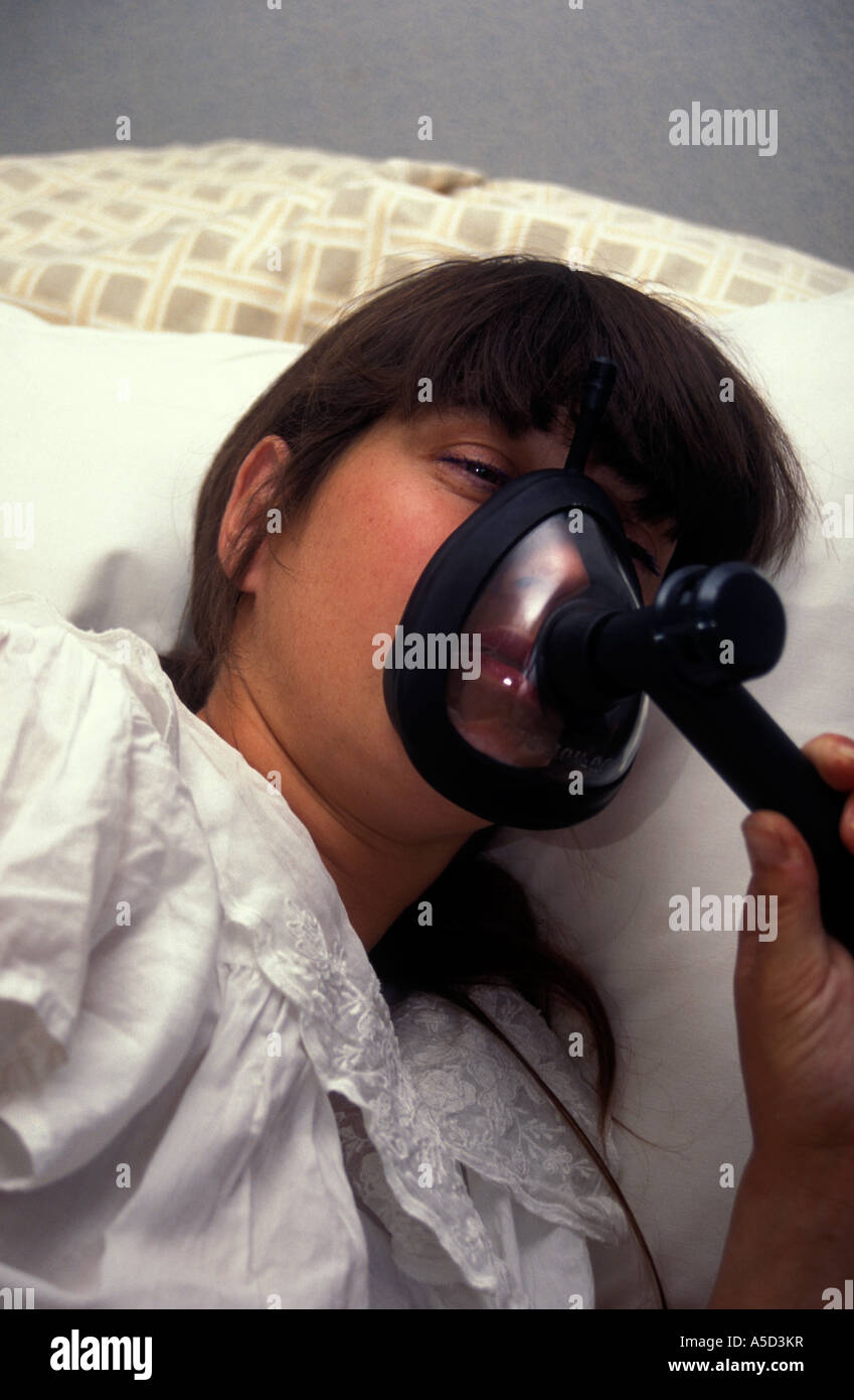 labouring woman using gas and air mask for pain relief Stock Photo