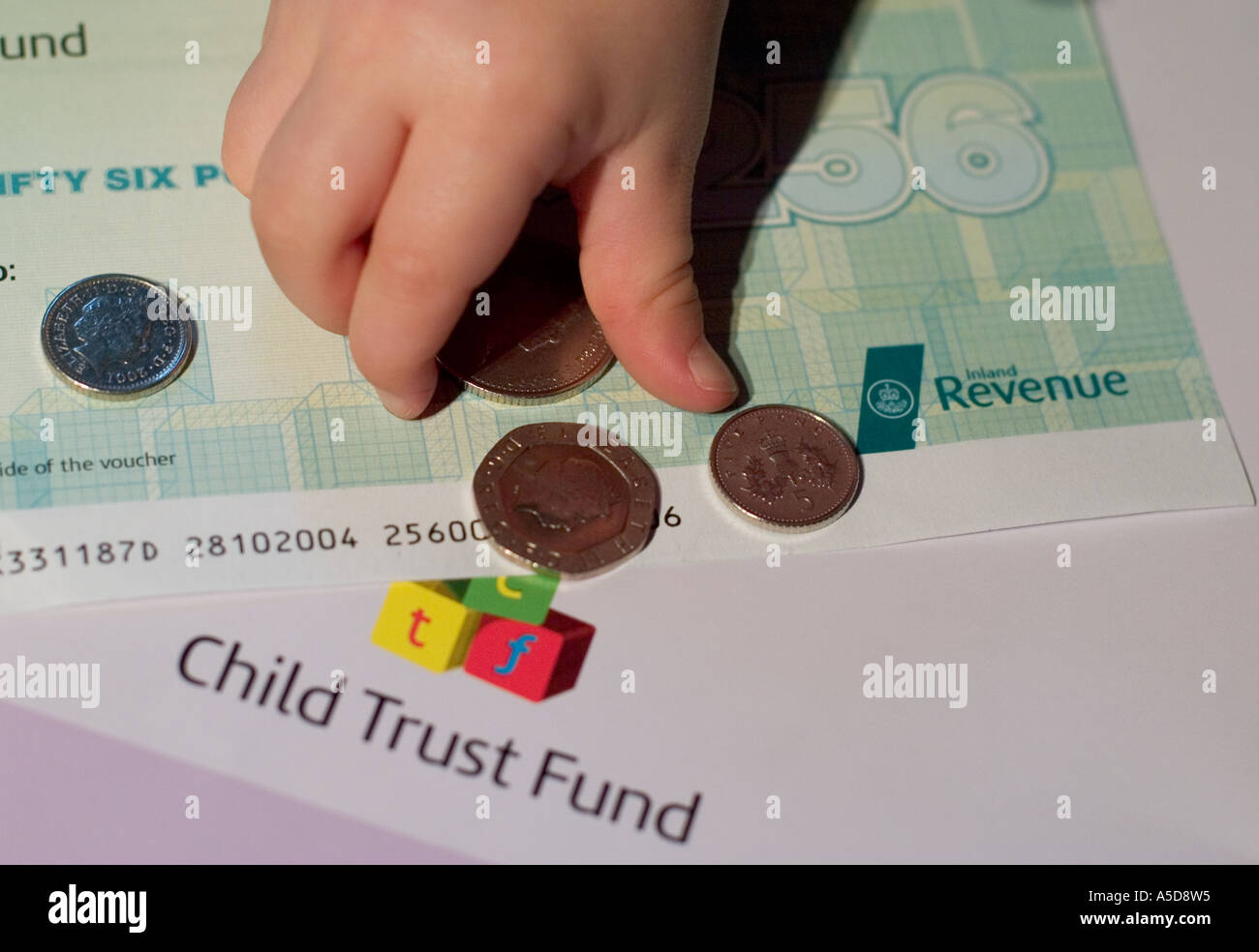 Child trust fund leaflet and voucher with baby hands picking up money