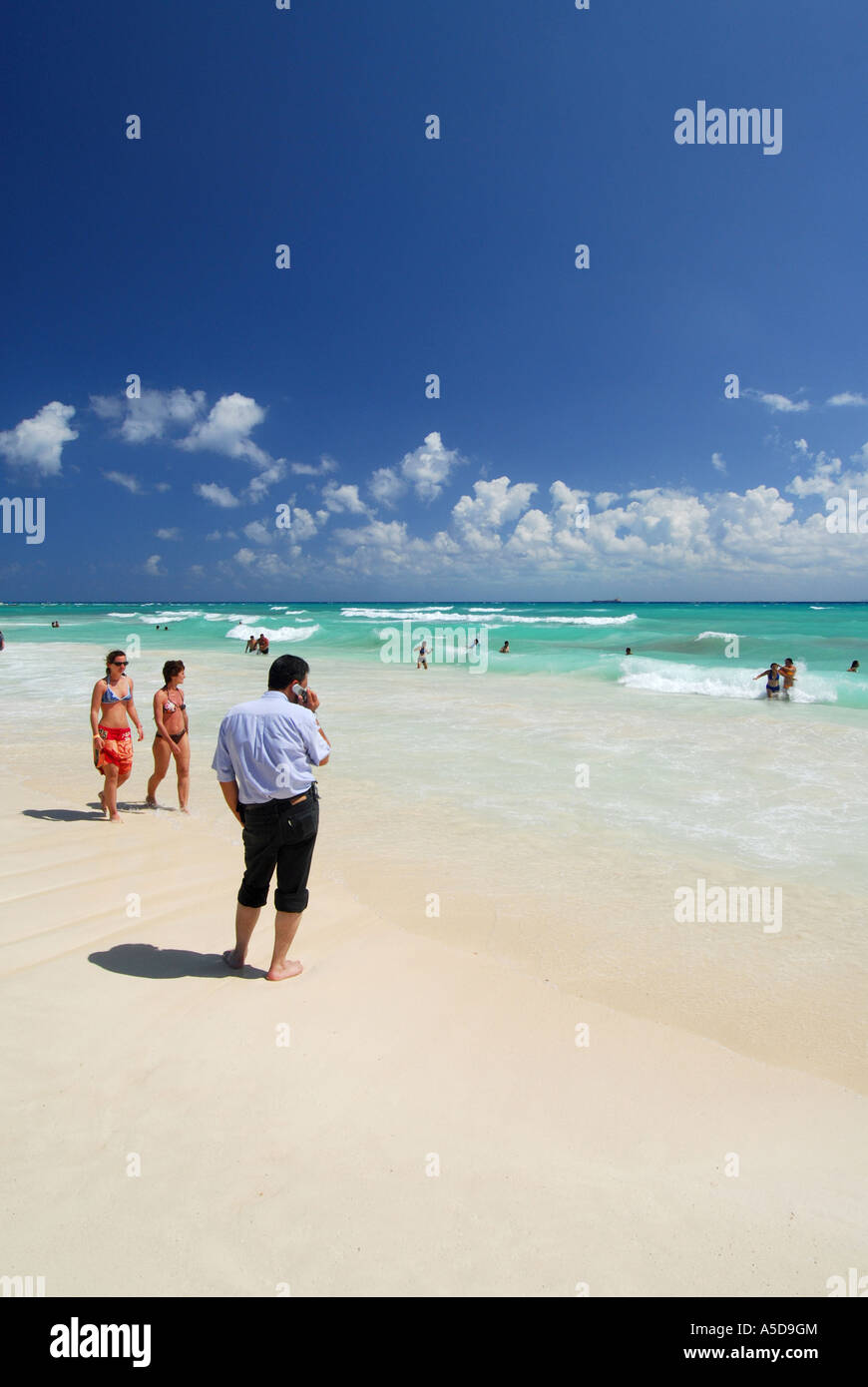 Man on mobile phone on the the beach at Playa del Carmen Yucatan peninsular Mexico Stock Photo