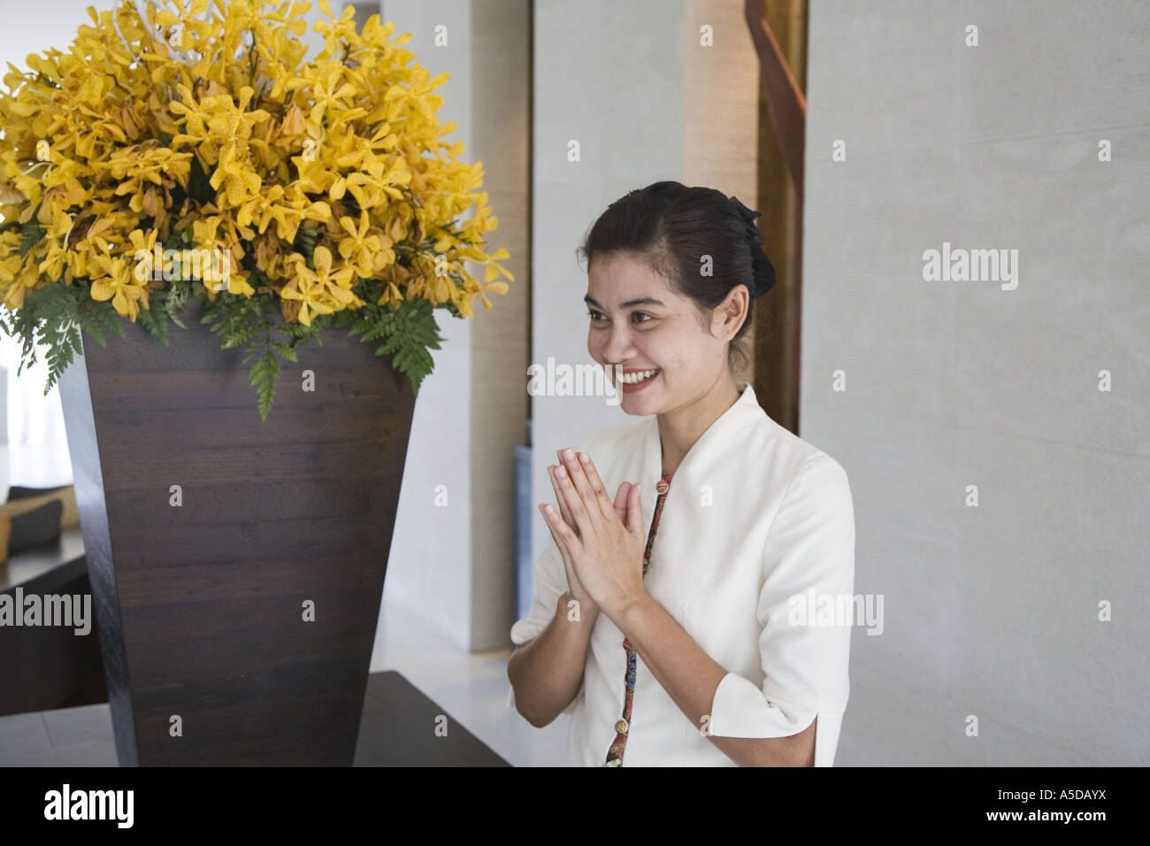 Female hotel worker at Five Star hotel posing in interior with