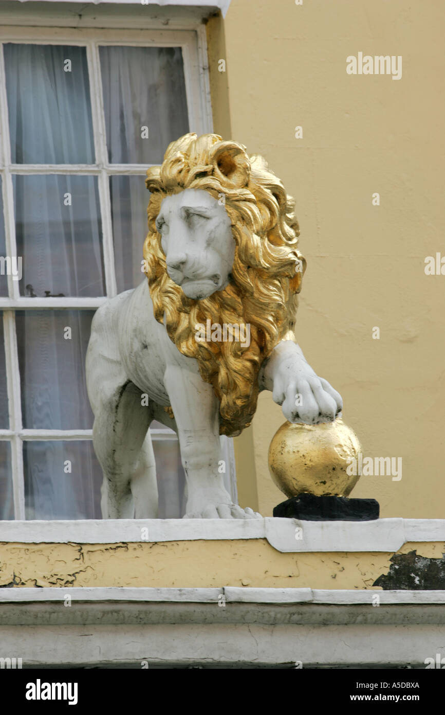 White Lion with his paw on a golden ball above the entrance to the White Lion Hotel, Upton Upon Severn, Worcestershire Stock Photo
