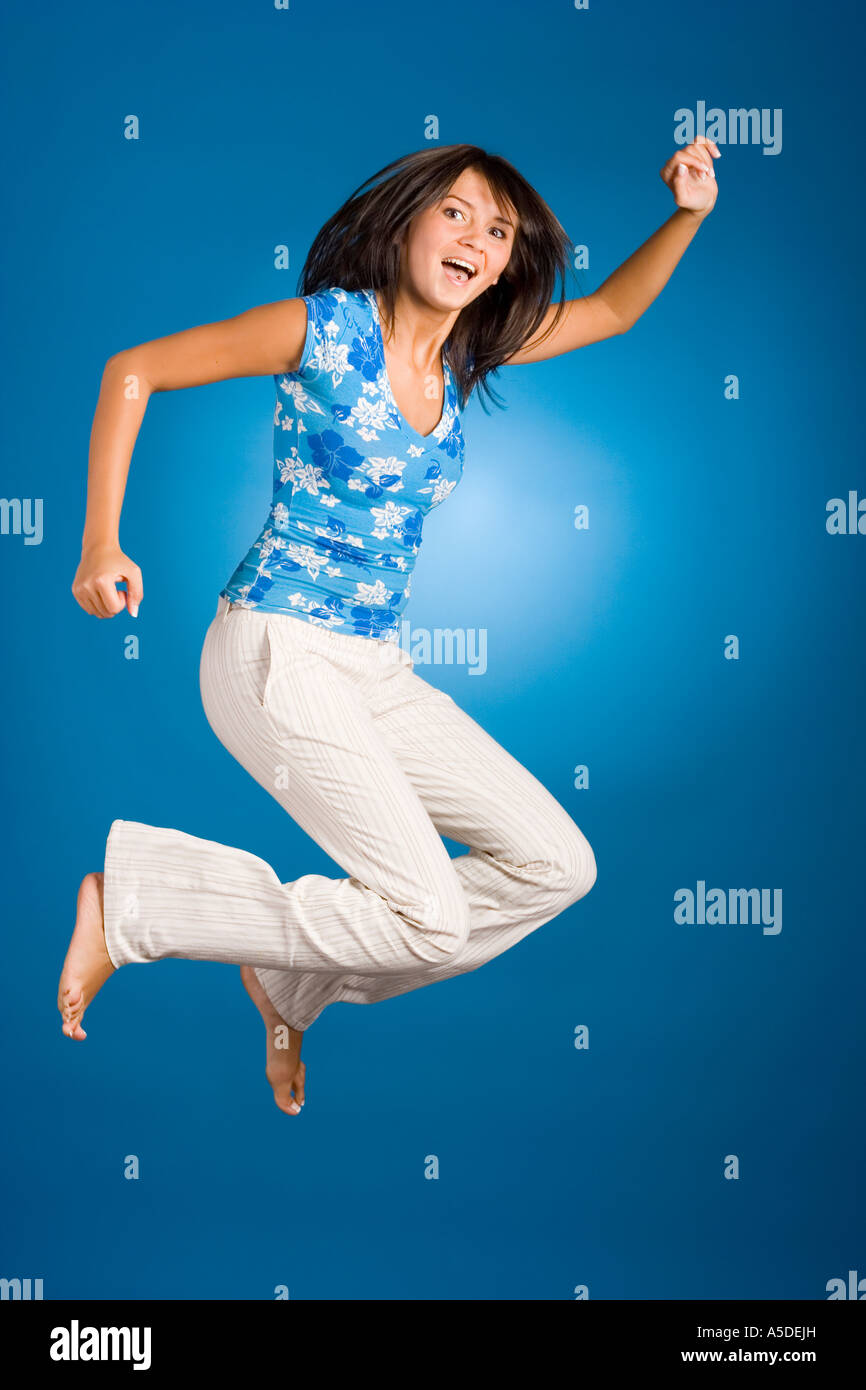 jumping happy woman on the blue background Stock Photo - Alamy