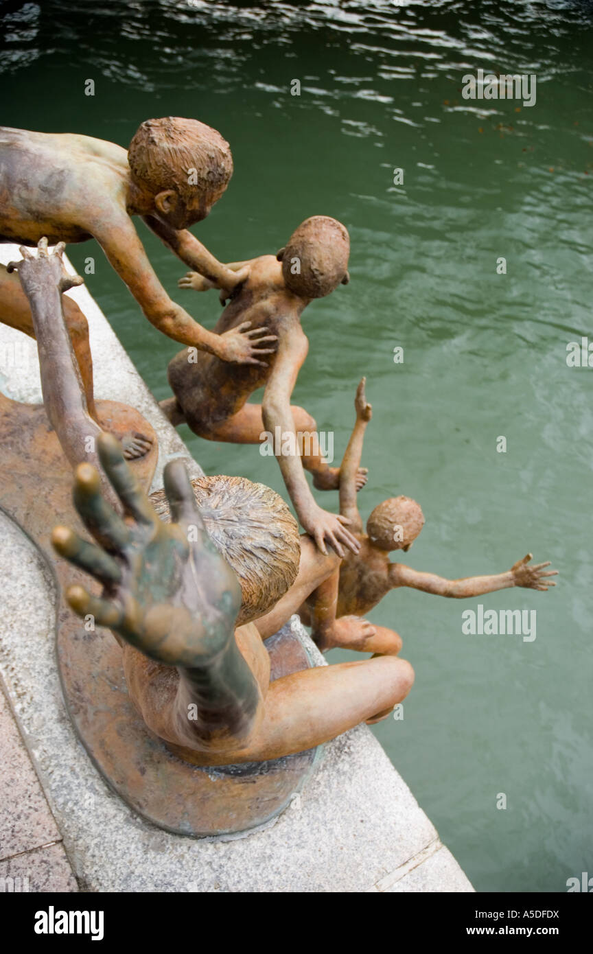 Stock photo of The First Generation a sculpture depicting kids playing in the Sinapore River near the Cavenagh Bridge Stock Photo