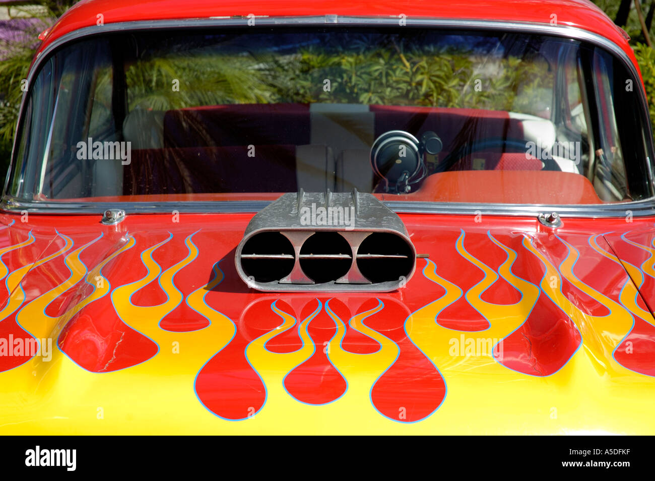 Closeup of classic American vehicle with exposed carburetor and custom