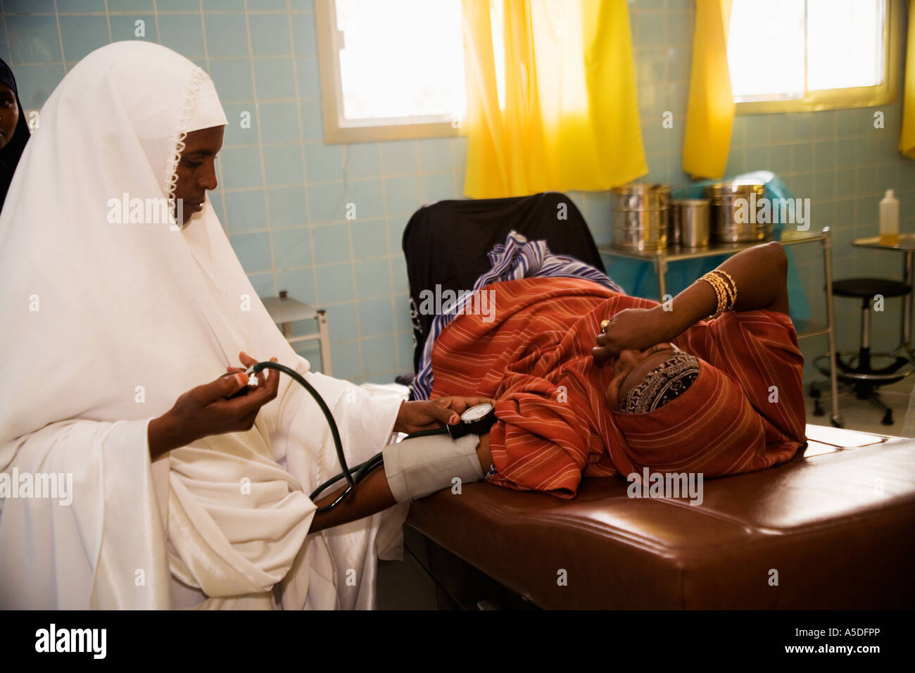 Pregnant woman having blood pressure checked by midwife in delivery room in  Edna Maternity Hospital, Hargeisa, Somaliland Stock Photo