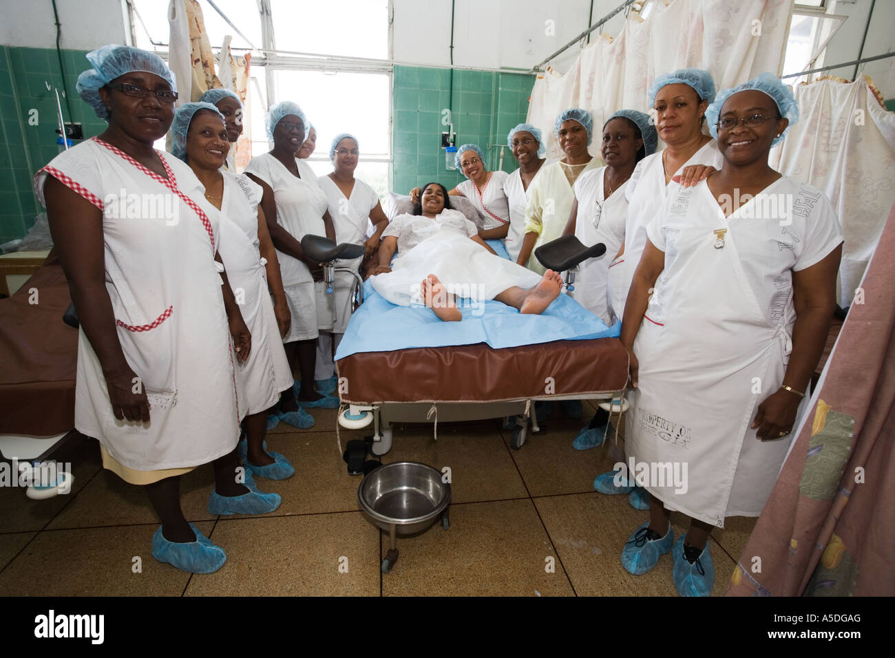 Team of midwives surround a woman who had just given birth in San Fernando  Maternity Hospital in Trinidad Stock Photo