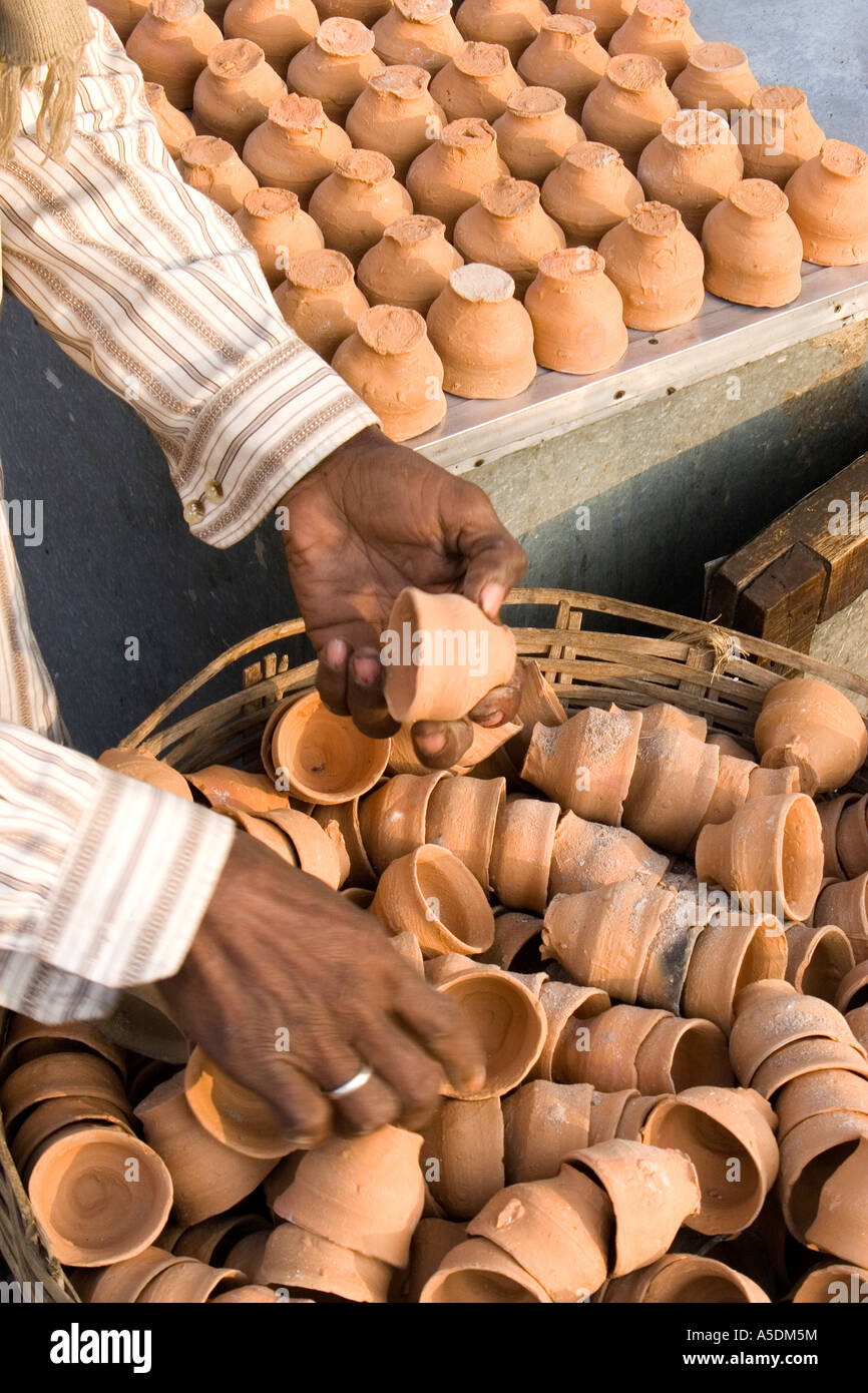 Detail of man sorting clay tea cups, India Stock Photo Alamy
