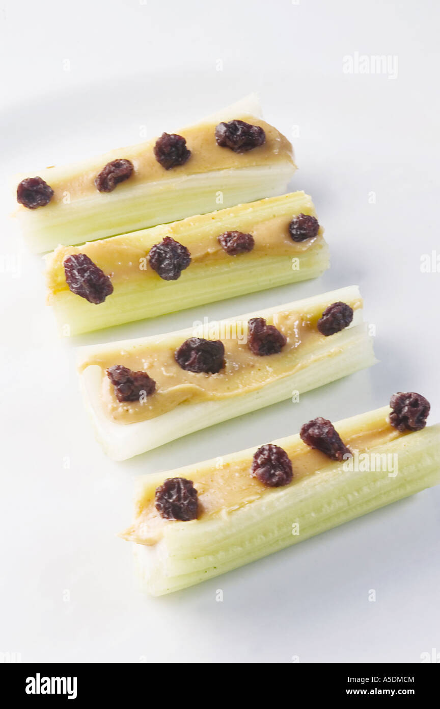 Ants on a log - celery sticks filled with peanut butter and topped with raisins Stock Photo