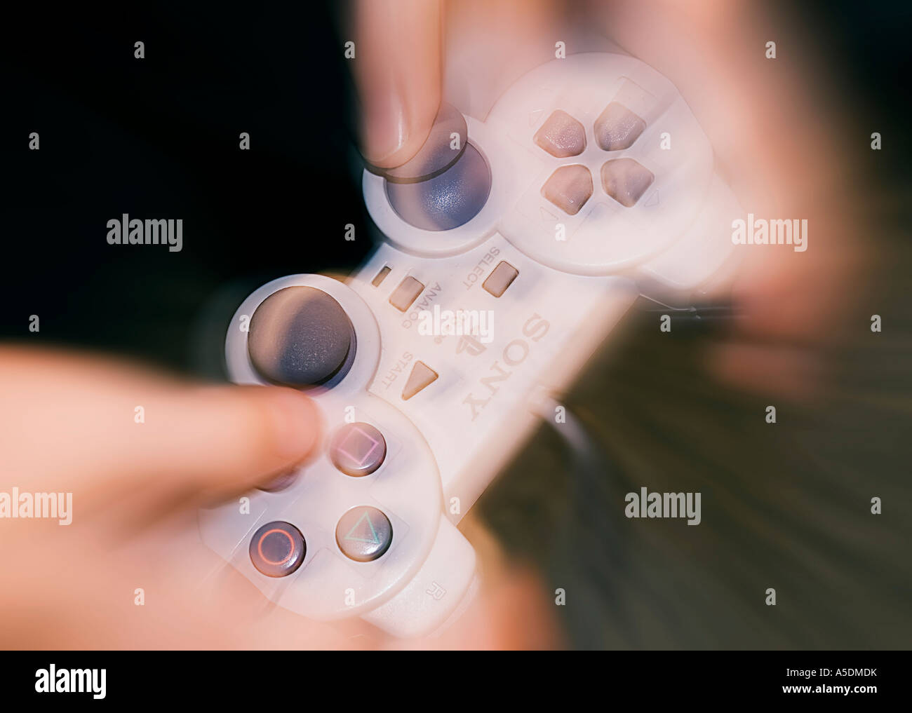 Boy's hands holding Playstation games controller Stock Photo