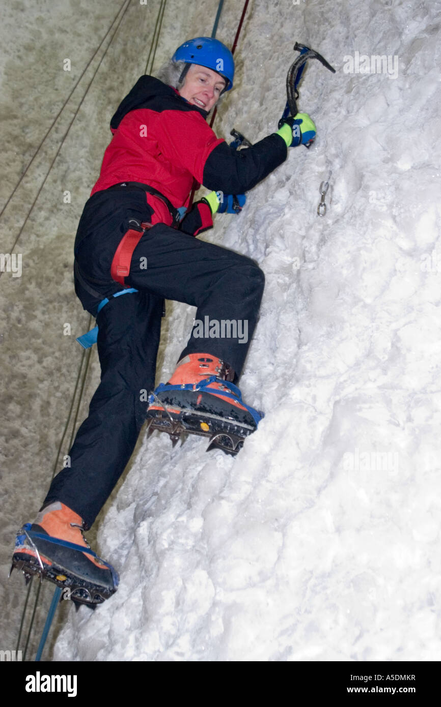 Female ascending an ice climbing wall at the Ice Factor Climbing Centre