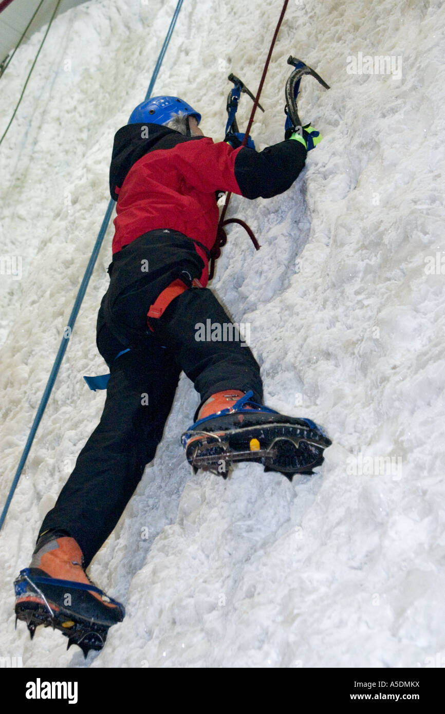 Female ascending an ice climbing wall at the Ice Factor Climbing Centre