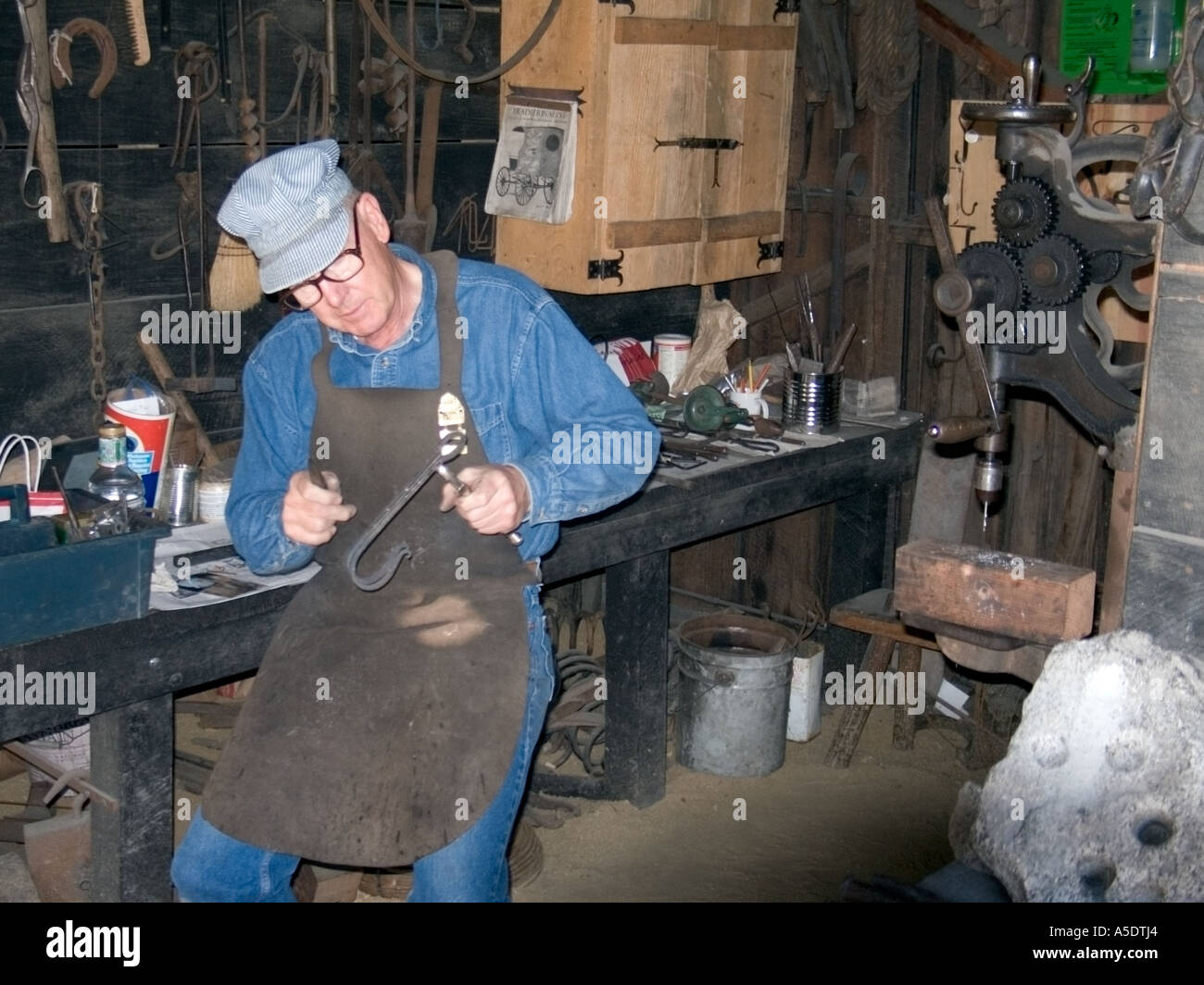 iron worker craftsman  demonstrates old tools  from the California Gold Rush era Stock Photo