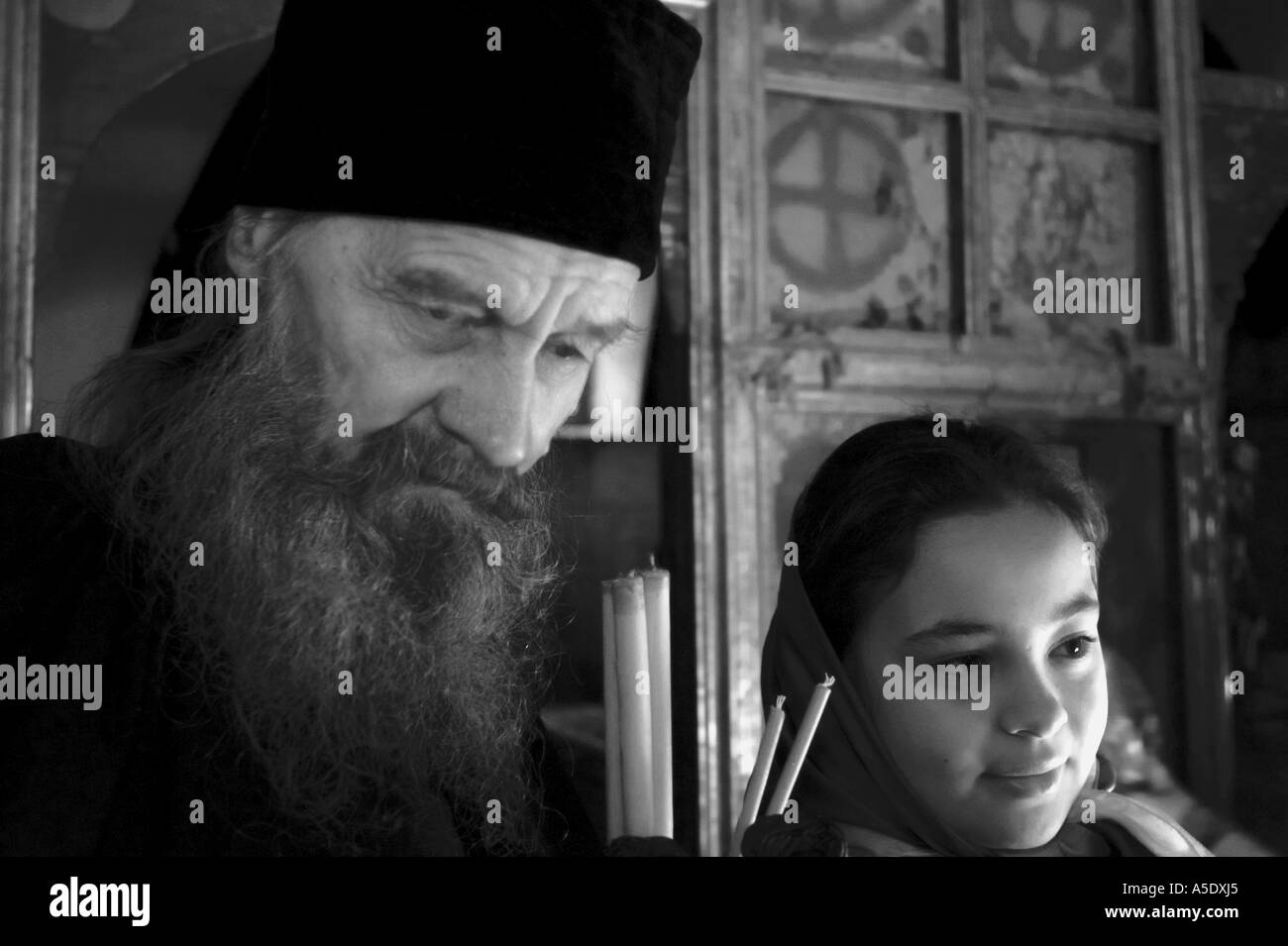 A priest and a young girl during the ceremony at Kasae al Yehud on the Jordan River Stock Photo