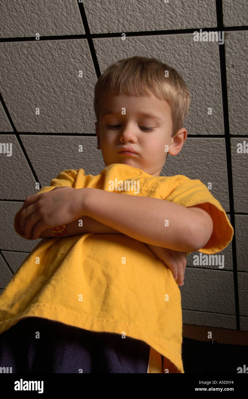 4 year old boy lowers head in shame Stock Photo Alamy