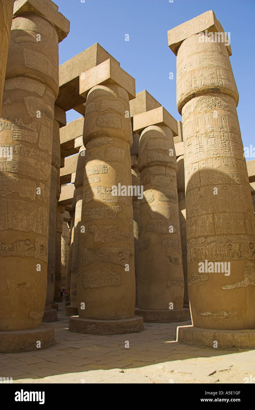Vertical Stone Columns in the Temple of Karnak, Luxor, Egypt, Decorated with Hieroglyphics and Pictures of the Ancient Egyptian Stock Photo