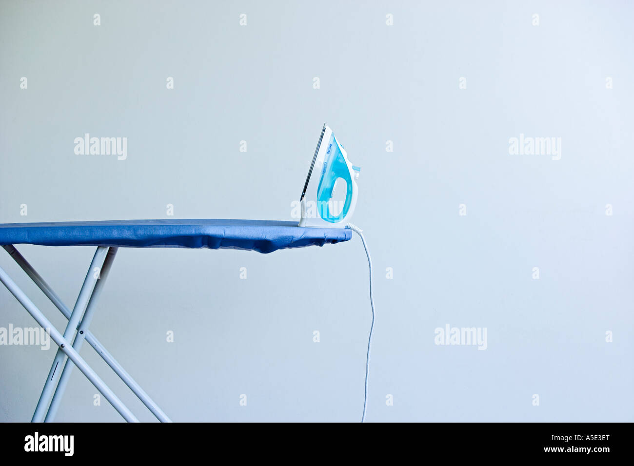 Iron on an Ironing Board Stock Photo Alamy