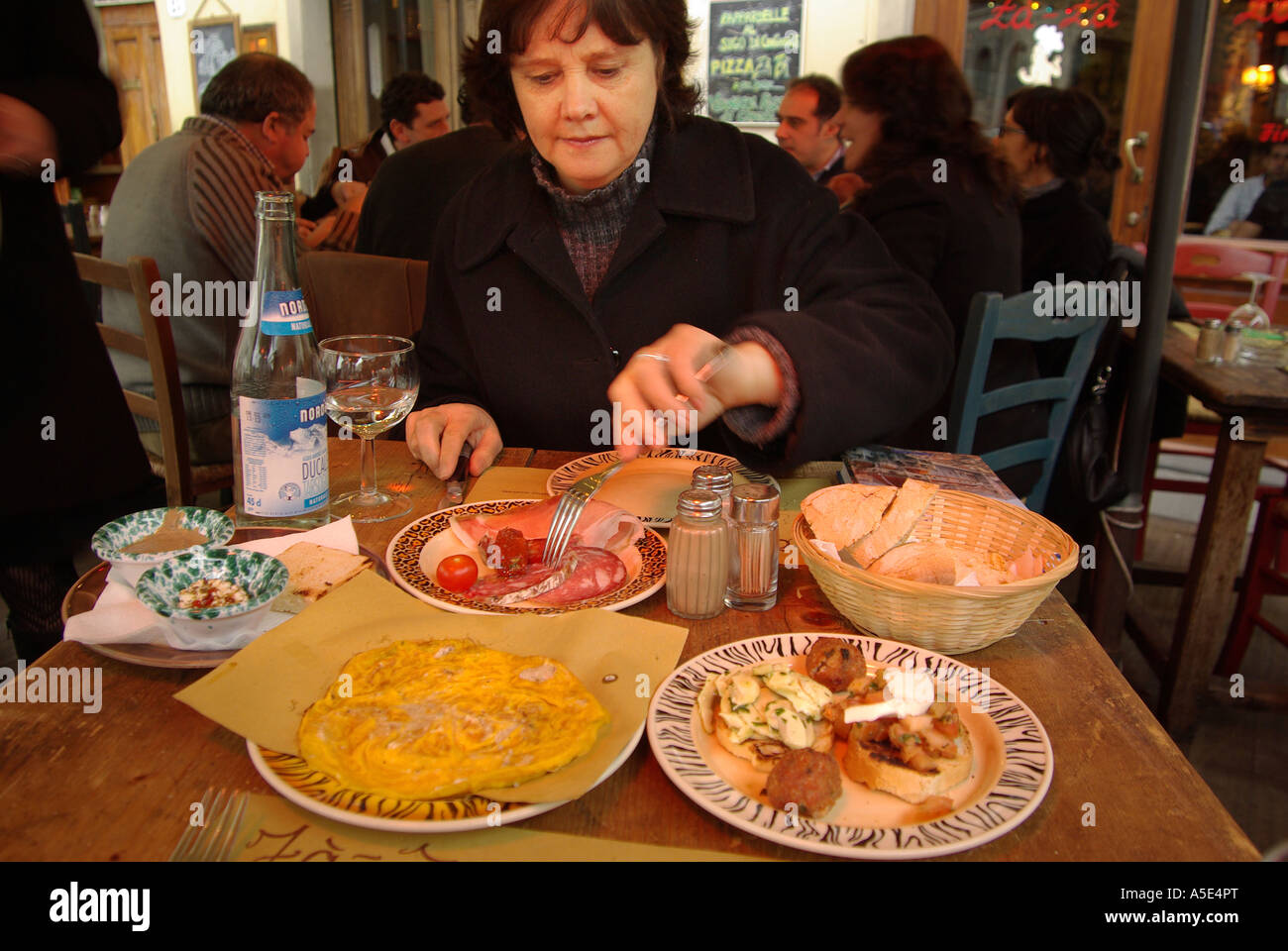 Single female tourist eating alone in Zàzà restaurant in Florence