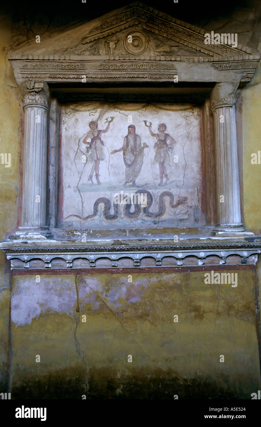 Intricate paintings on the walls in the lararium in the House of Vettii, Pompeii, Italy. Stock Photo