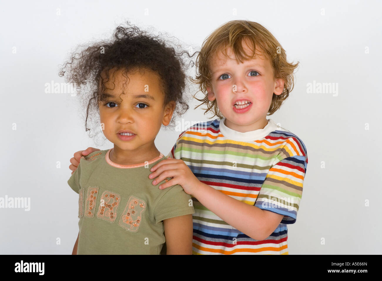 A Beautiful Mixed Race Girl And A Blonde Boy Stand Together Stock