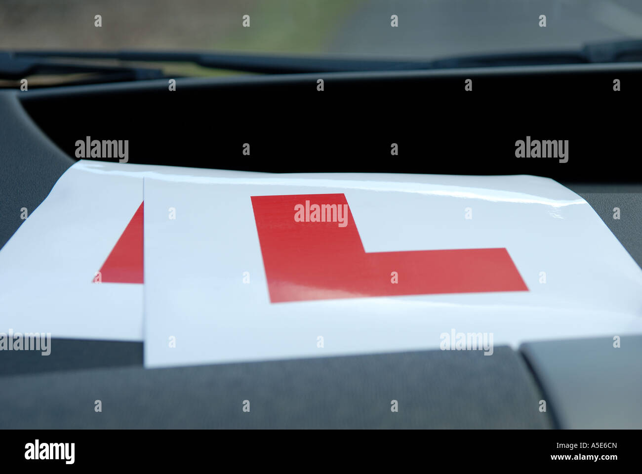 L Plates on Dash of Car. Stock Photo