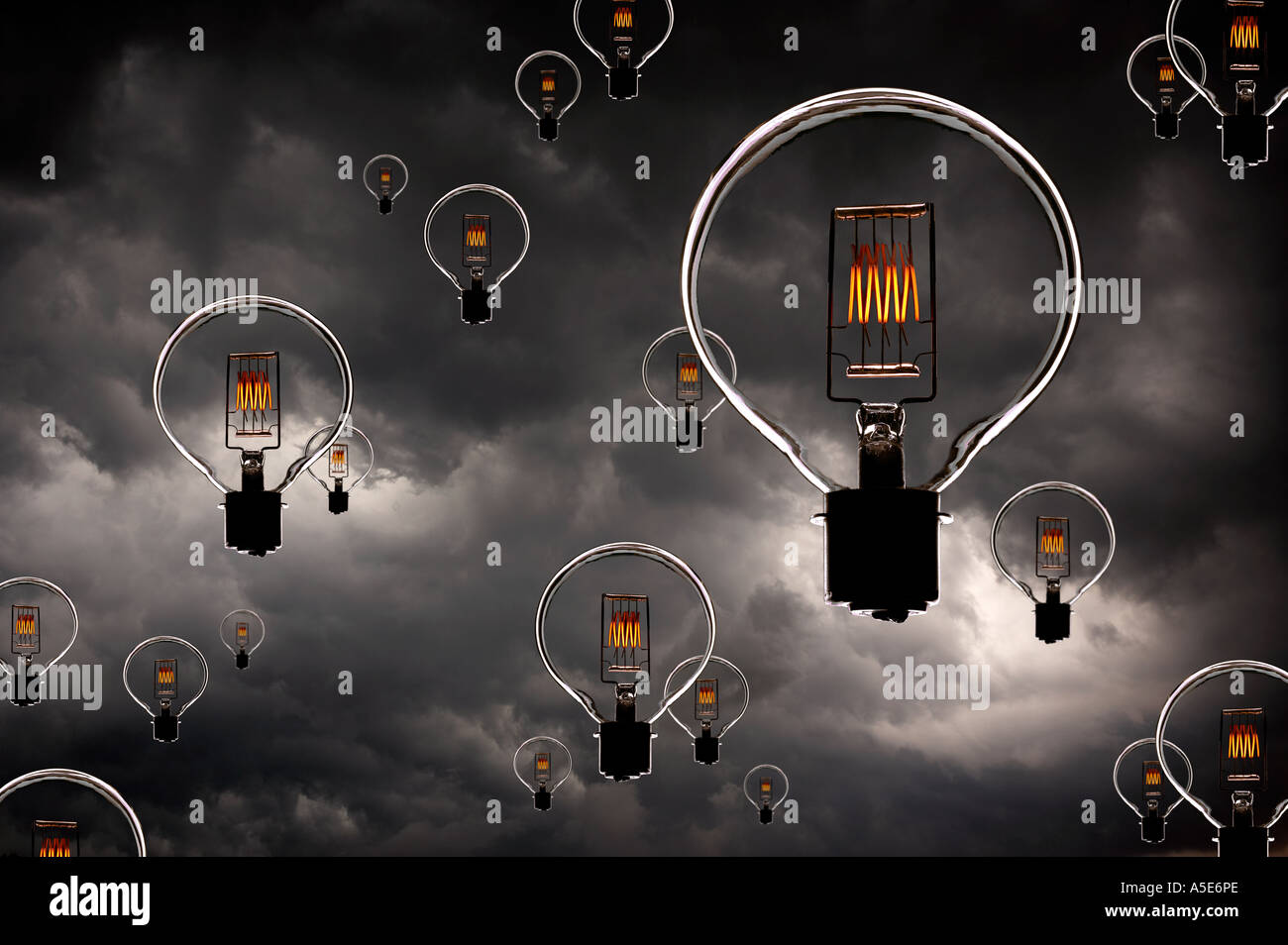ELECTRIC LIGHT BULBS WITH GLOWING FILAMENTS FLOATING IN SKY WITH STORM