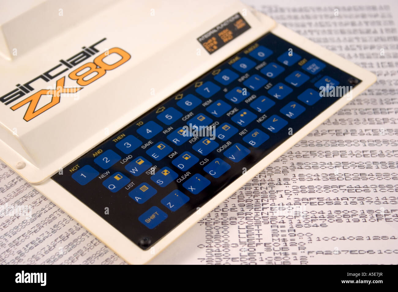 Sinclair ZX80 home computer on printout of BASIC programming language code Stock Photo