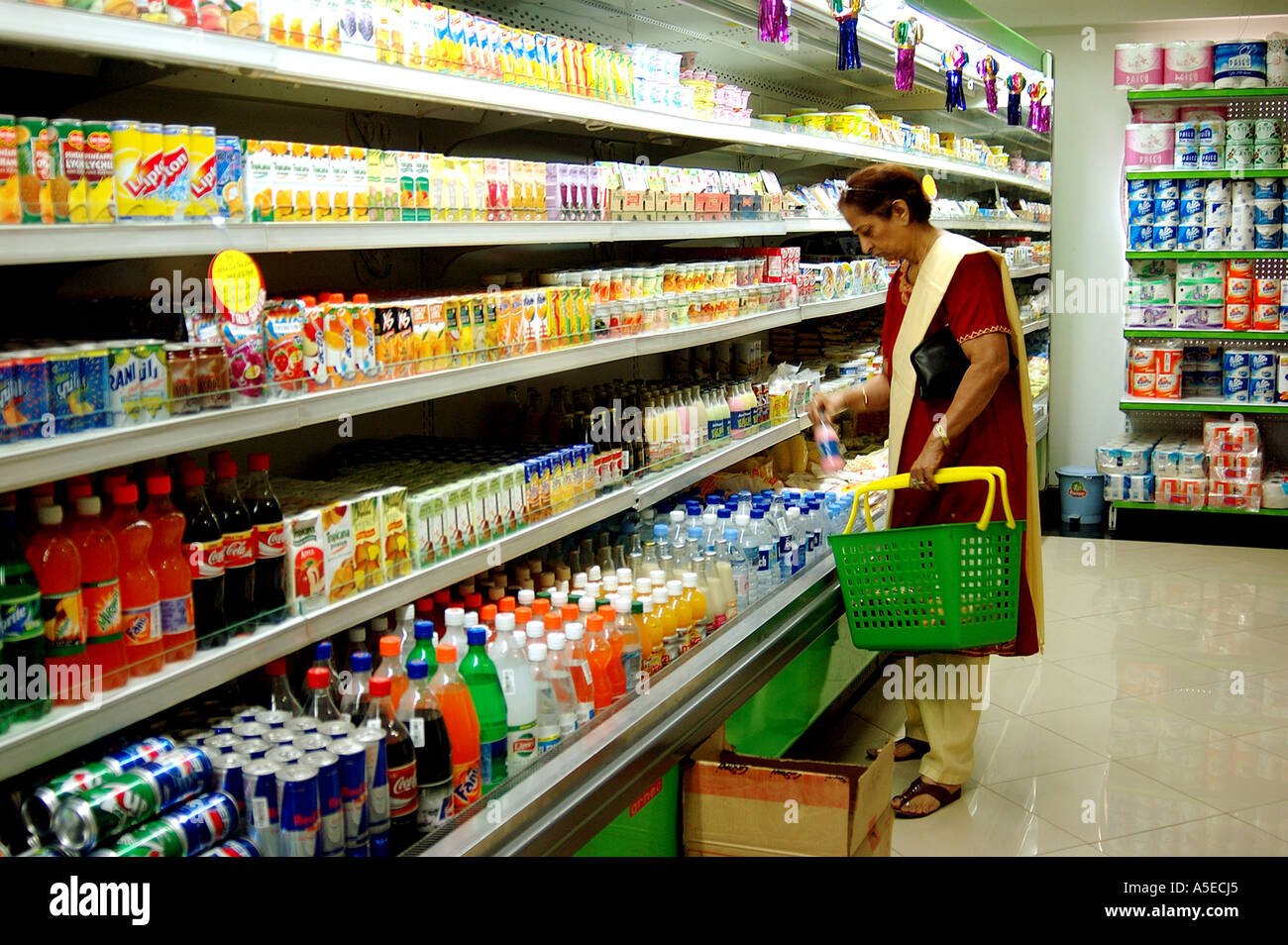 PKB77953 Woman buying products in Shopping Mall at Poona Maharashtra India Stock Photo