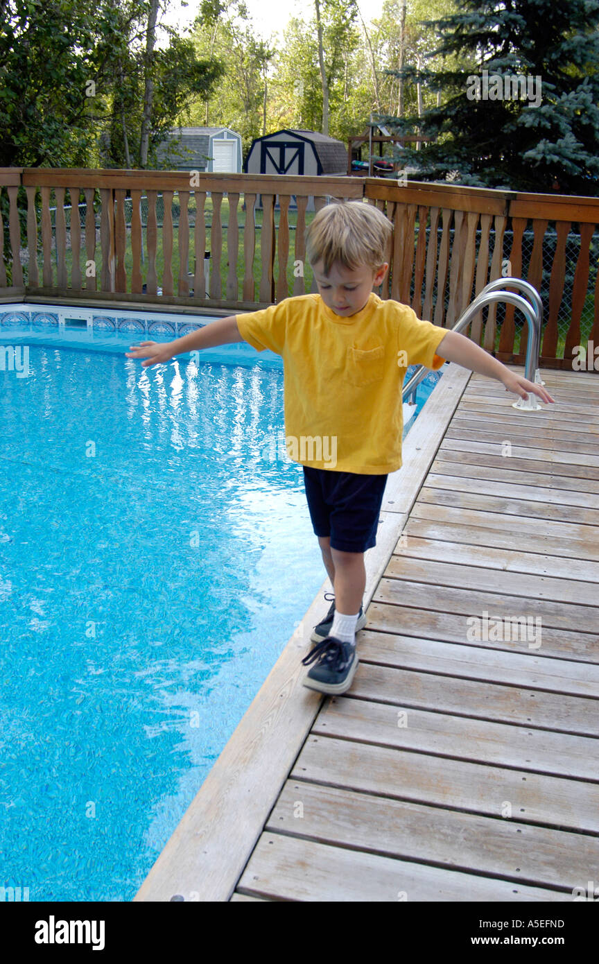 4 Year Old Balancing On Edge Of Swimming Pool 2 Stock Photo Alamy