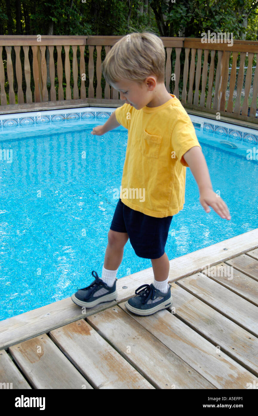 4 Year Old Balancing On Edge Of Swimming Pool 3 Stock Photo Alamy