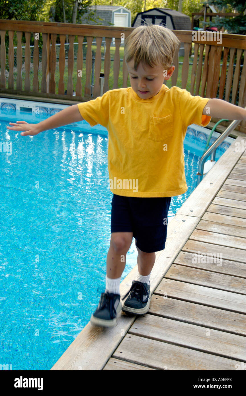 4 Year Old Balancing On Edge Of Swimming Pool Stock Photo Alamy