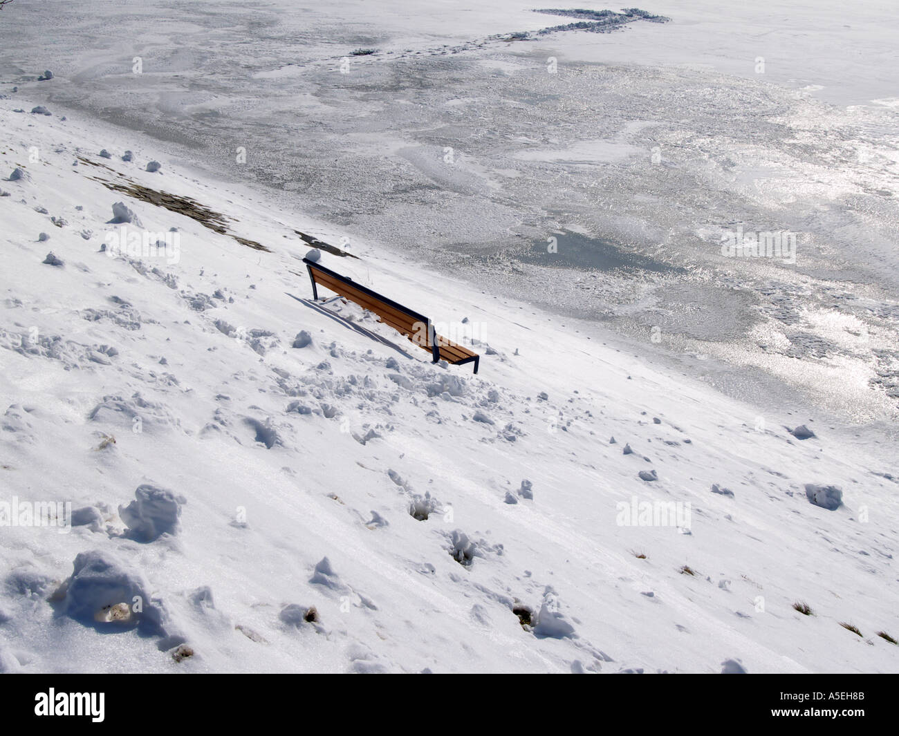 lonely park bench on a snowy hill Stock Photo