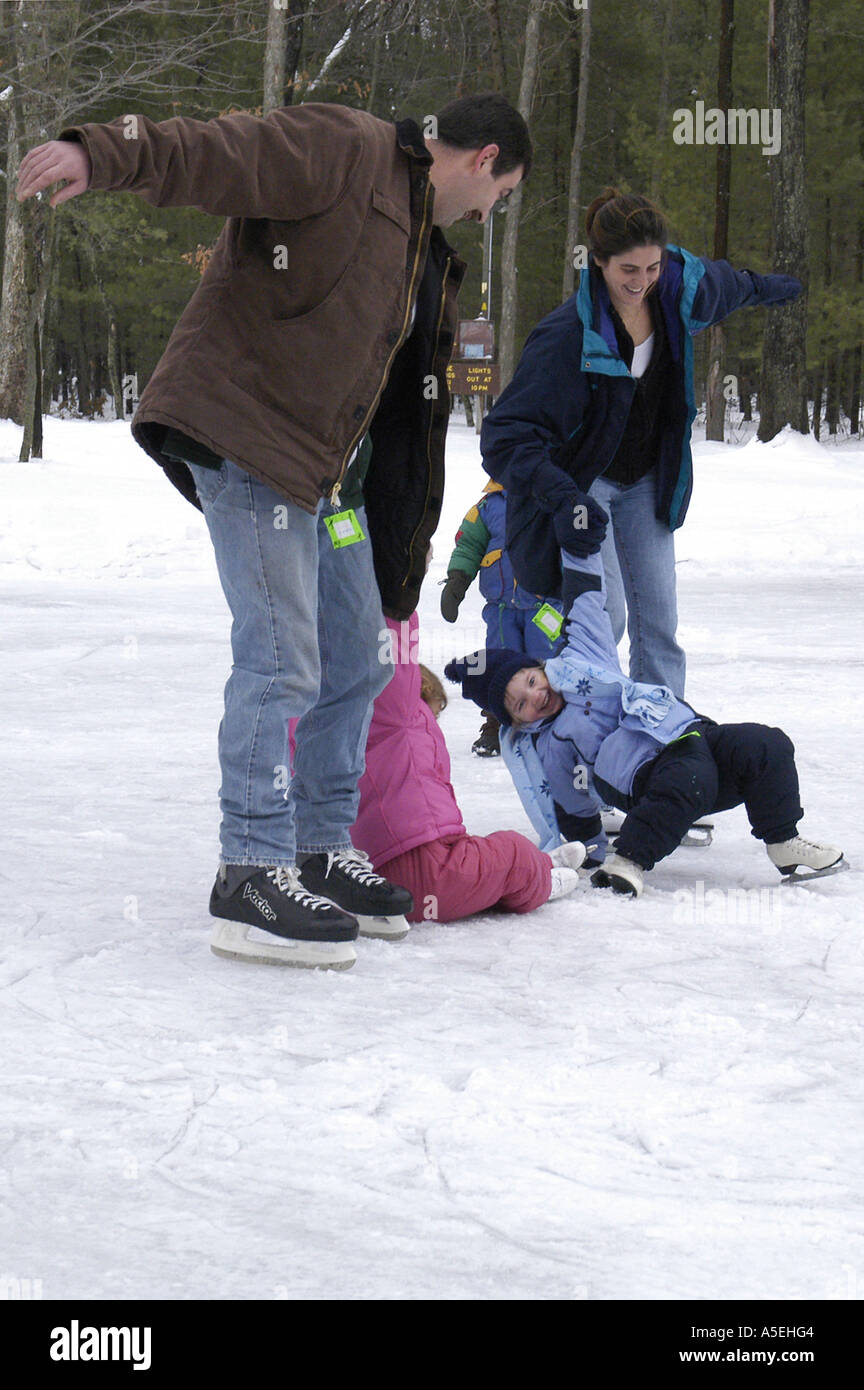 P12 047 Family Ice Skating, Two little girls falling, Muskegon Winter