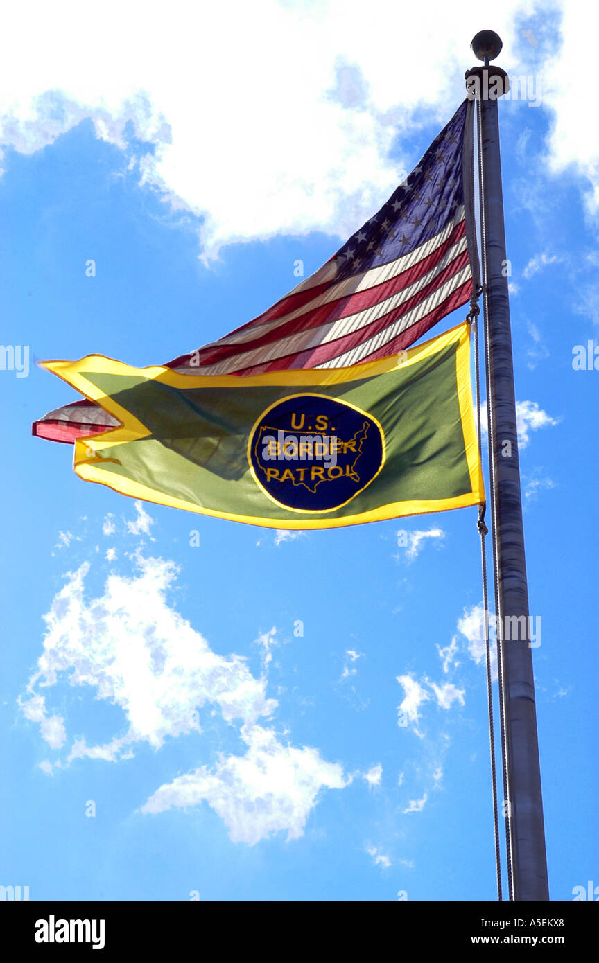 USA, US Border Patrol flags flying in front of Blue Sky, clouds