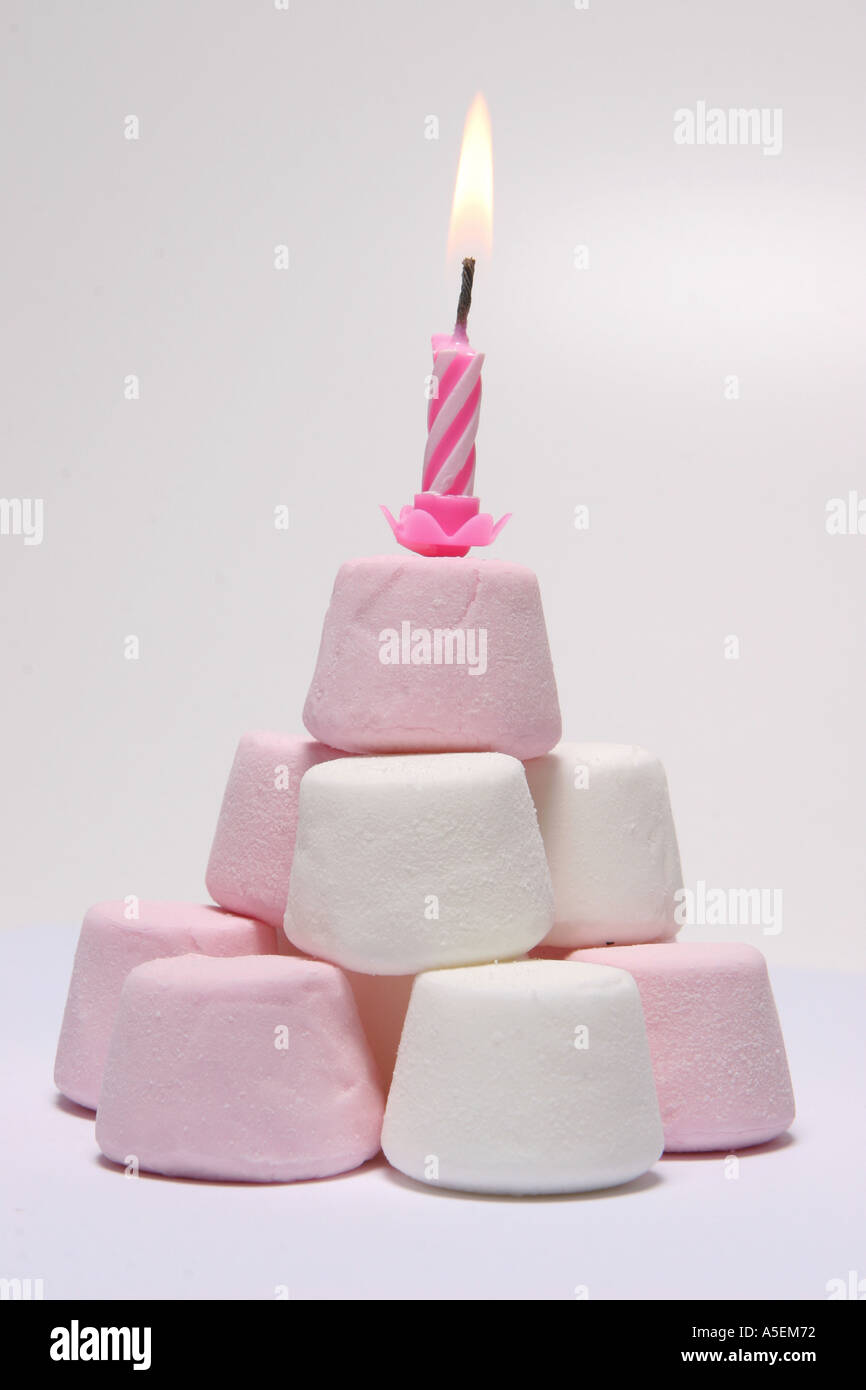 Pyramid of marshmallows with candle in it Stock Photo