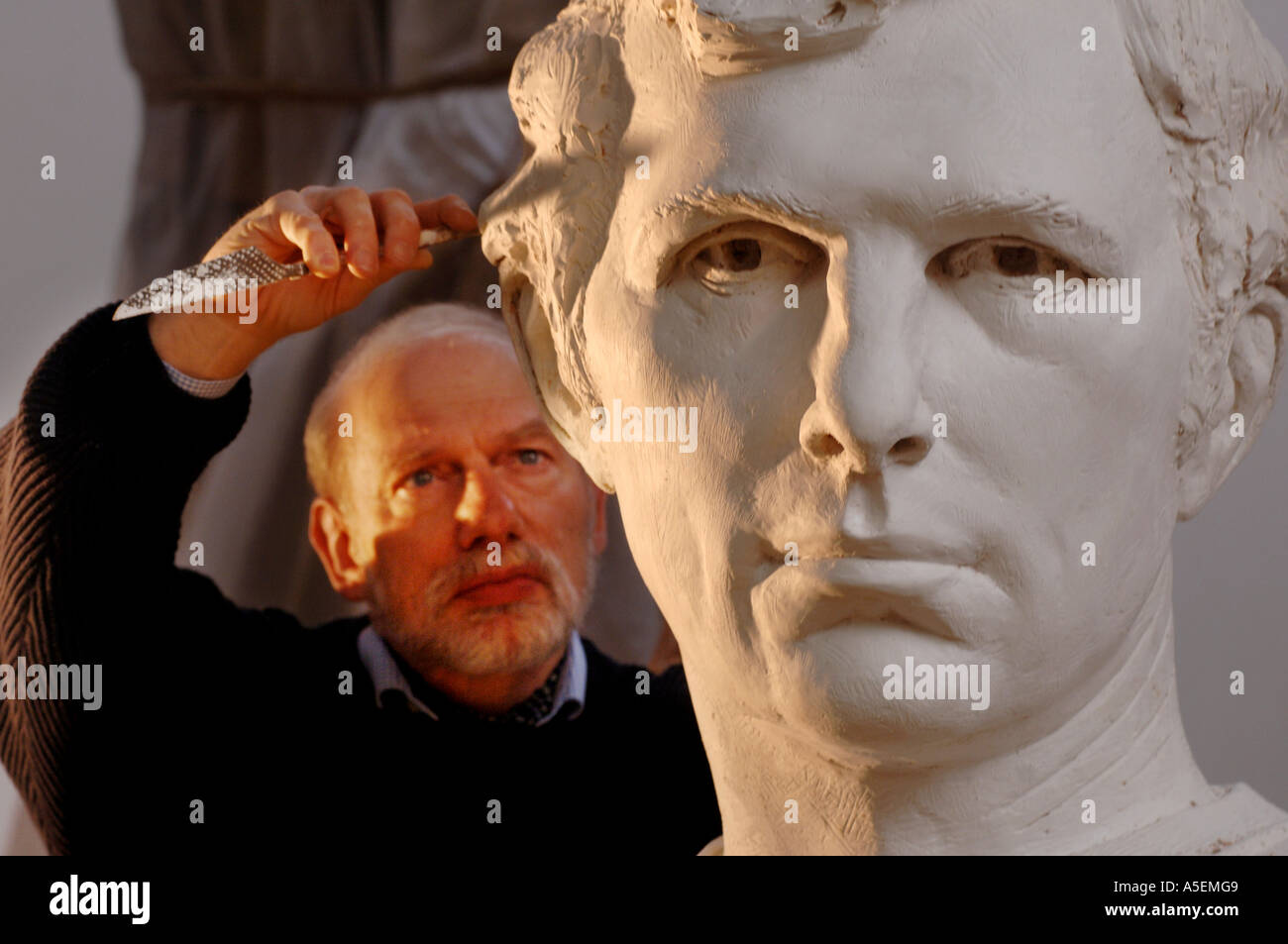 Sculptor Philip Jackson works on a portrait of footballer Bobby Moore for the new Wembley stadium Stock Photo